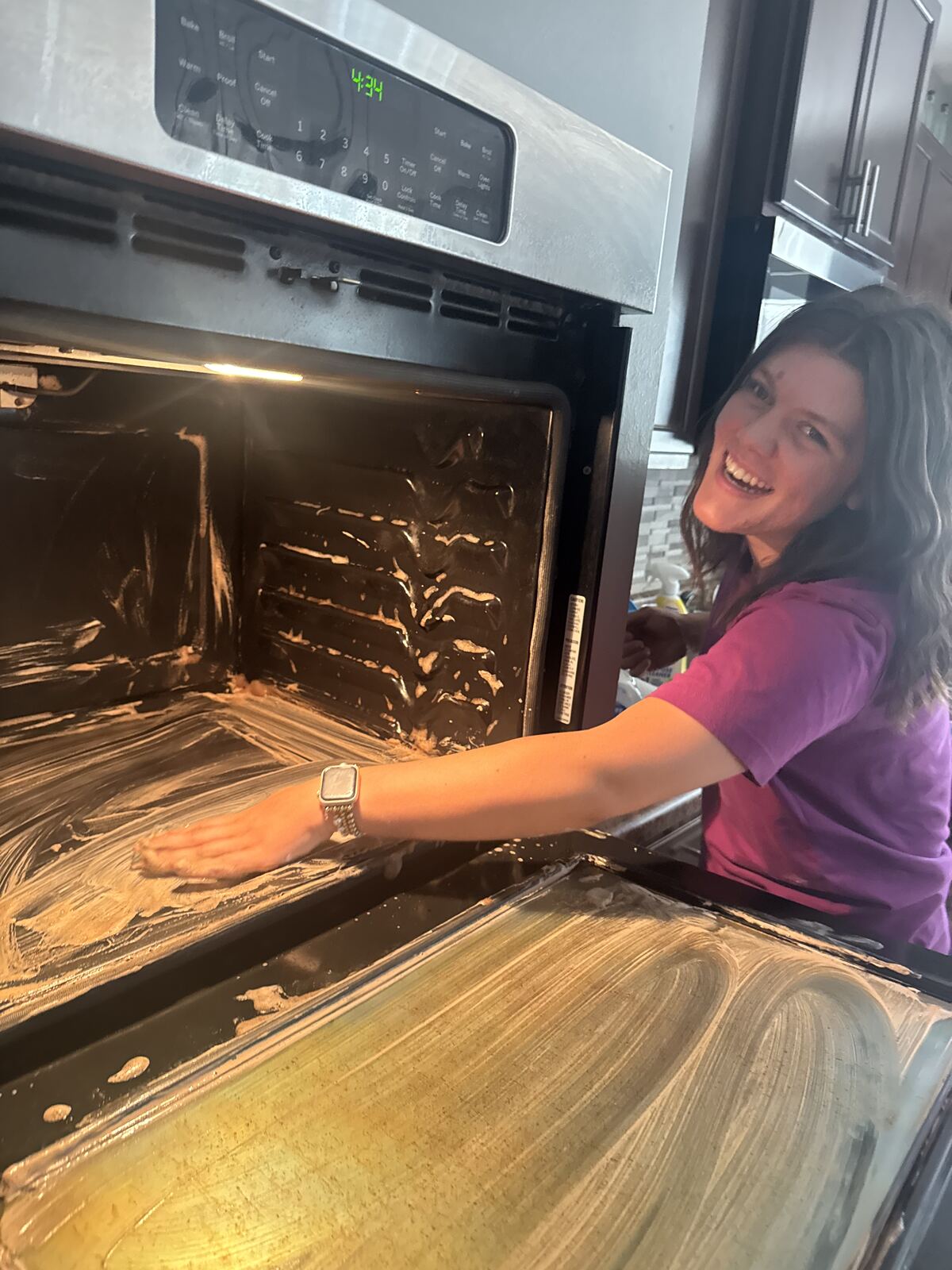 All Hands Cleaning team member hand-scrubbing the inside of an oven